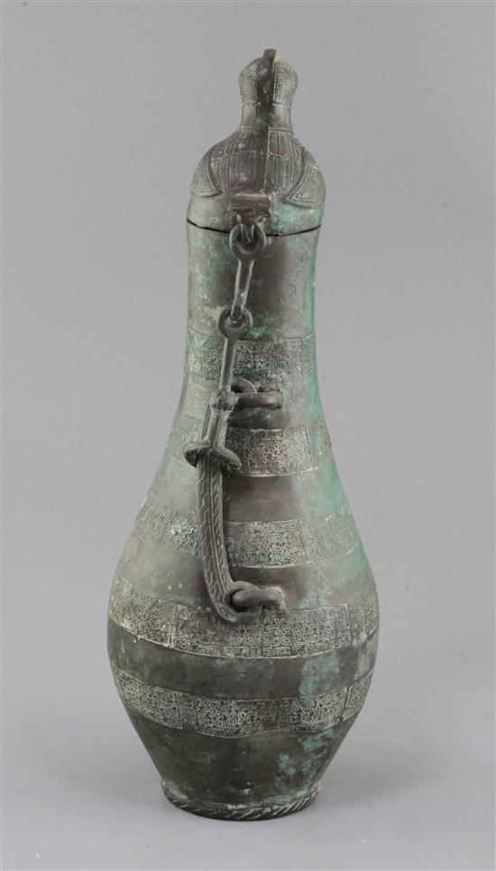 A Chinese archaic bronze flask-shaped ritual wine vessel, Hu, Eastern Zhou dynasty, 5th-4th century B.C., 36.5cm high, hole to base and